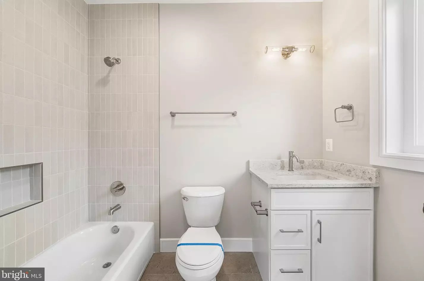 Full bathroom with soaking tub, tile surround and vanity