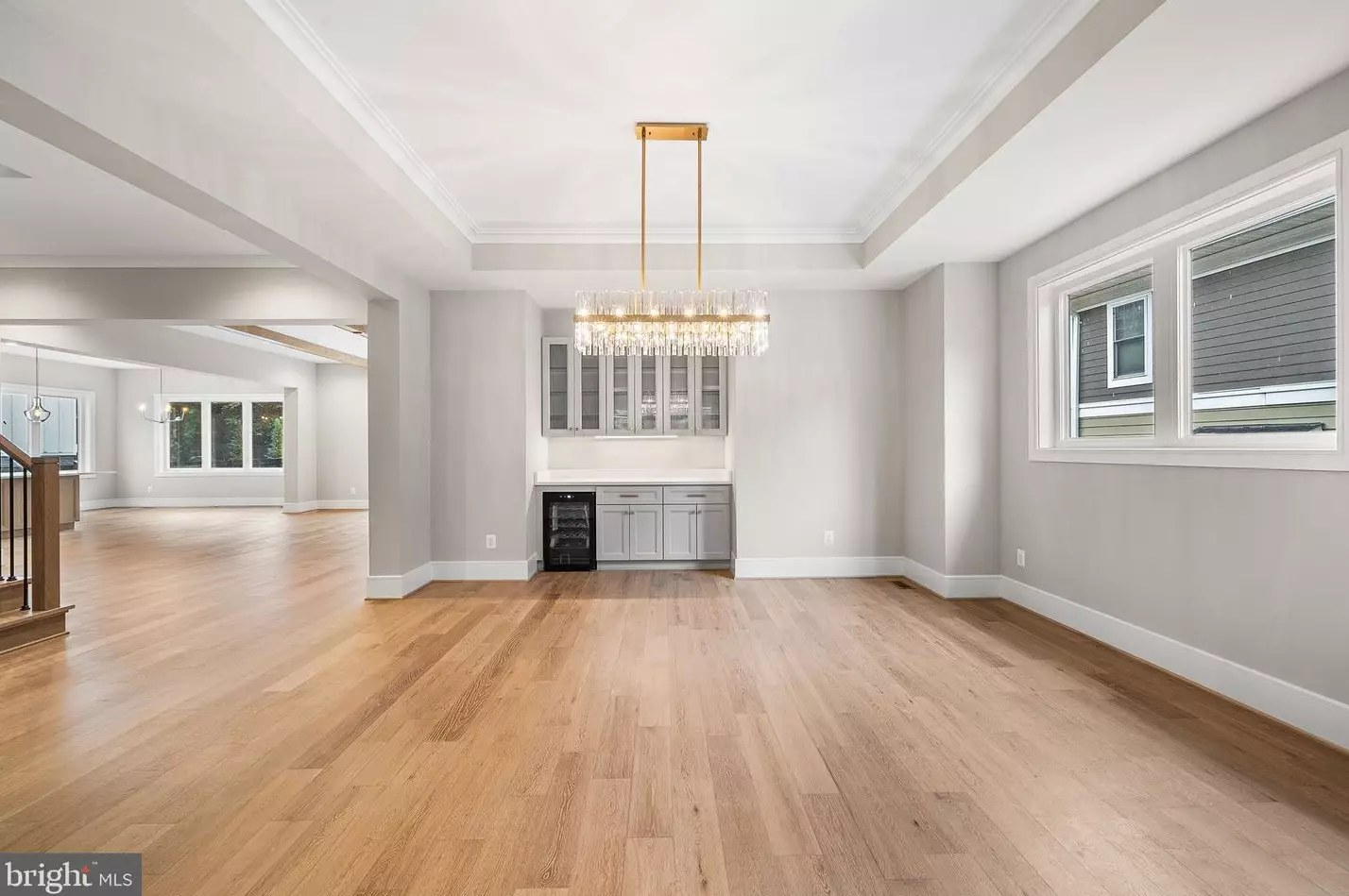Formal dining room with tray ceiling, chandelier and built-in beverage center