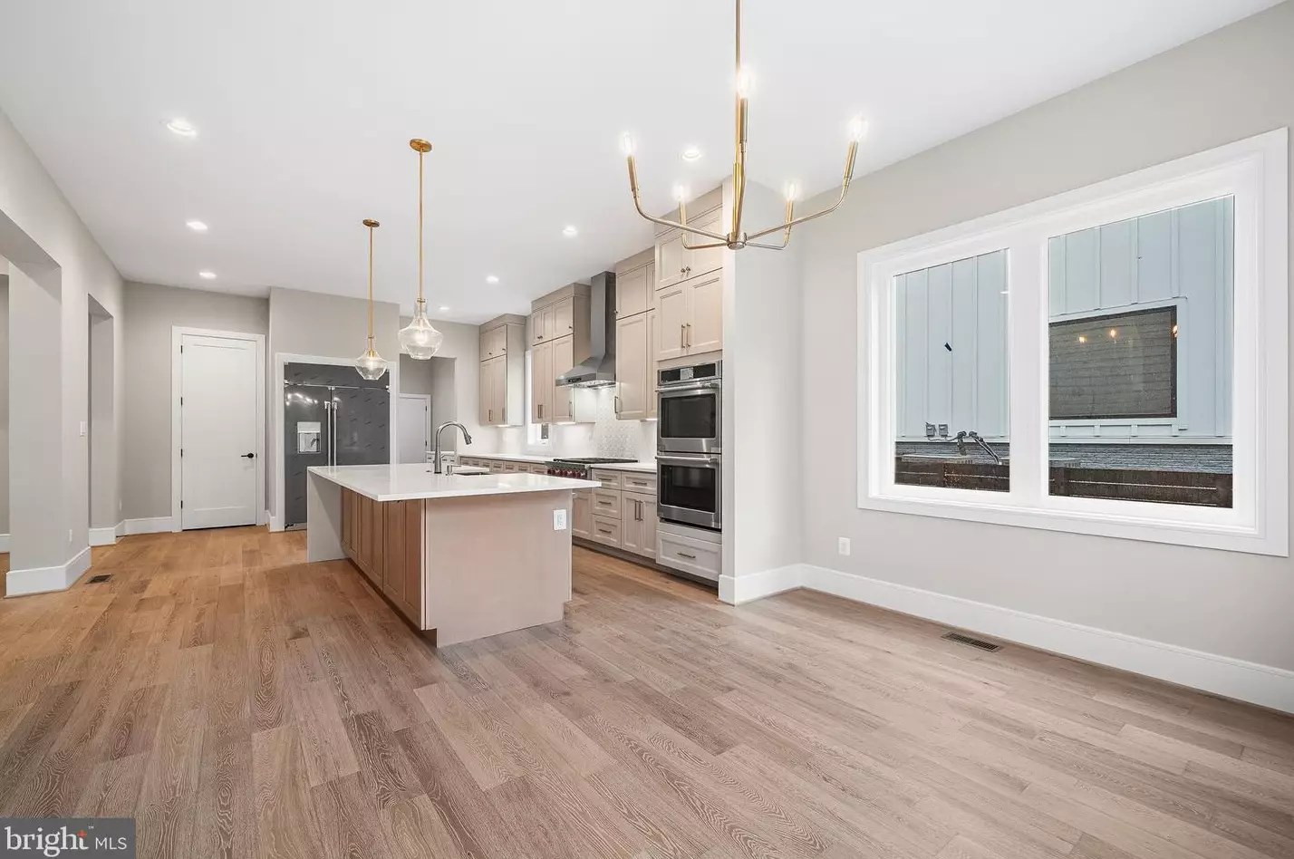 Breakfast area beside the kitchen with chandelier and windows
