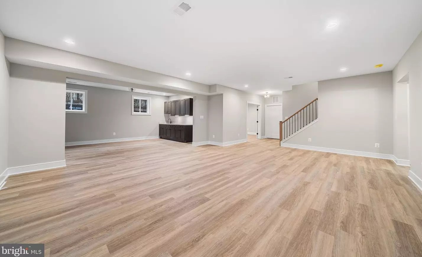 Finished lower-level recreation room open to the stair landing